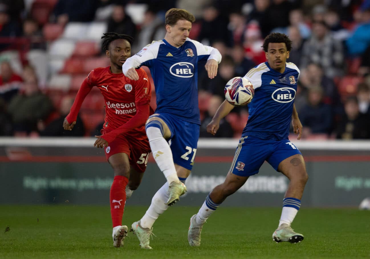 Barnsley v Exeter City, Barnsley, UK - 1 Apr 2025 Ryan Trevitt of Exeter City is pressured by Kelechi Nwakali of Barnsley during the EFL League 1 match between Barnsley and Exeter City at Oakwell Stadium, Barnsley on 1 April 2025 ( Copyright: xJakexManuell PPAUKx PPA-177010
